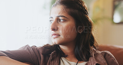 Buy stock photo Mental health, thinking and woman with depression, anxiety and unhappy on sofa in living room, house and home. Sad, emotional and concerned girl with stress, moody and miserable person on couch