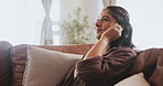 Woman, student and relax on sofa house listening to music with wireless earphones, radio and podcast in living room. Smile, female person and streaming audio, connection and subscription for peace