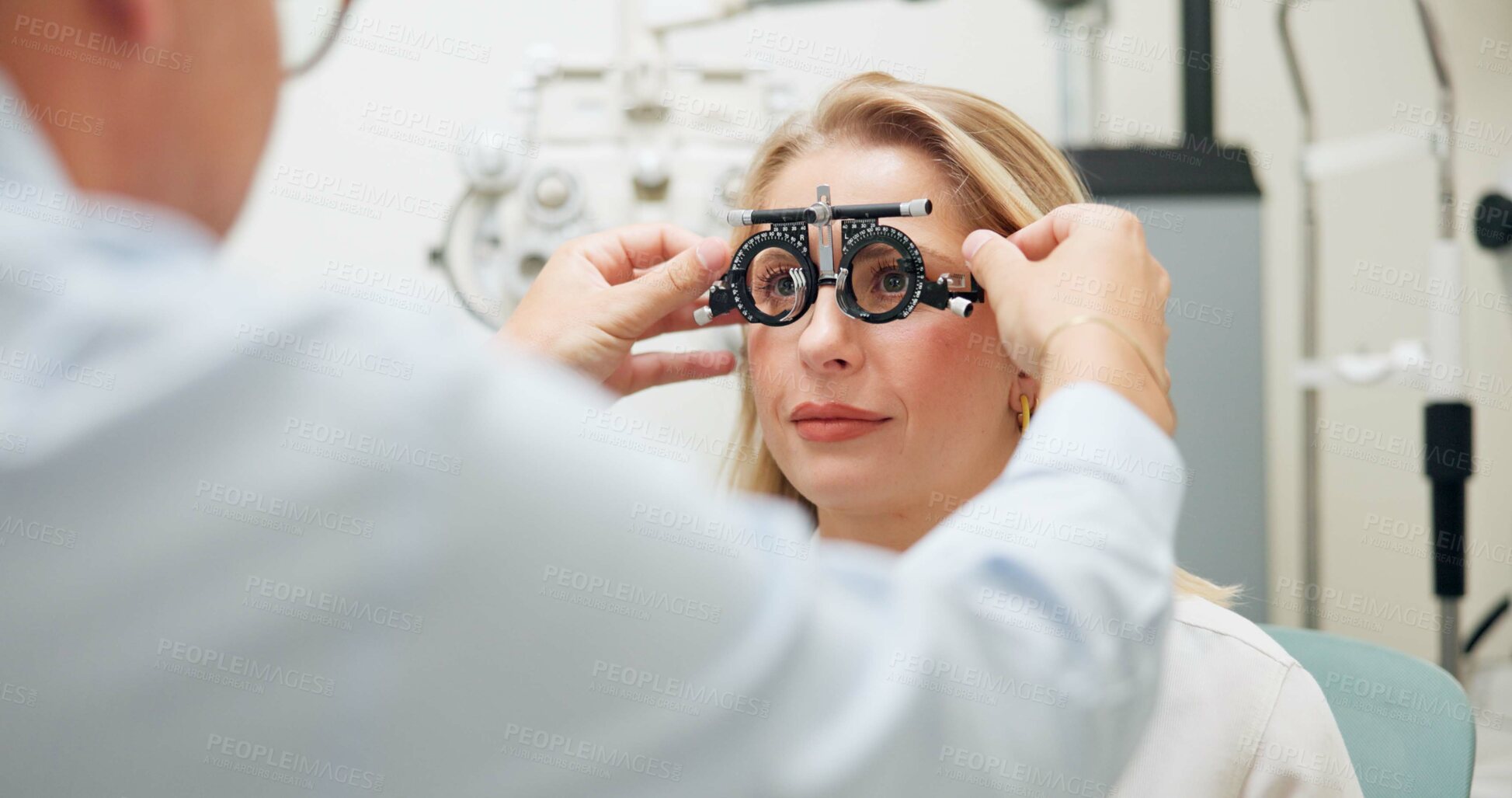 Buy stock photo Doctor, ophthalmologist and woman with test frame for eye health, consultation and exam in clinic. Optometry, trail and patient on lens for vision check, wellness and glasses for eyesight correction