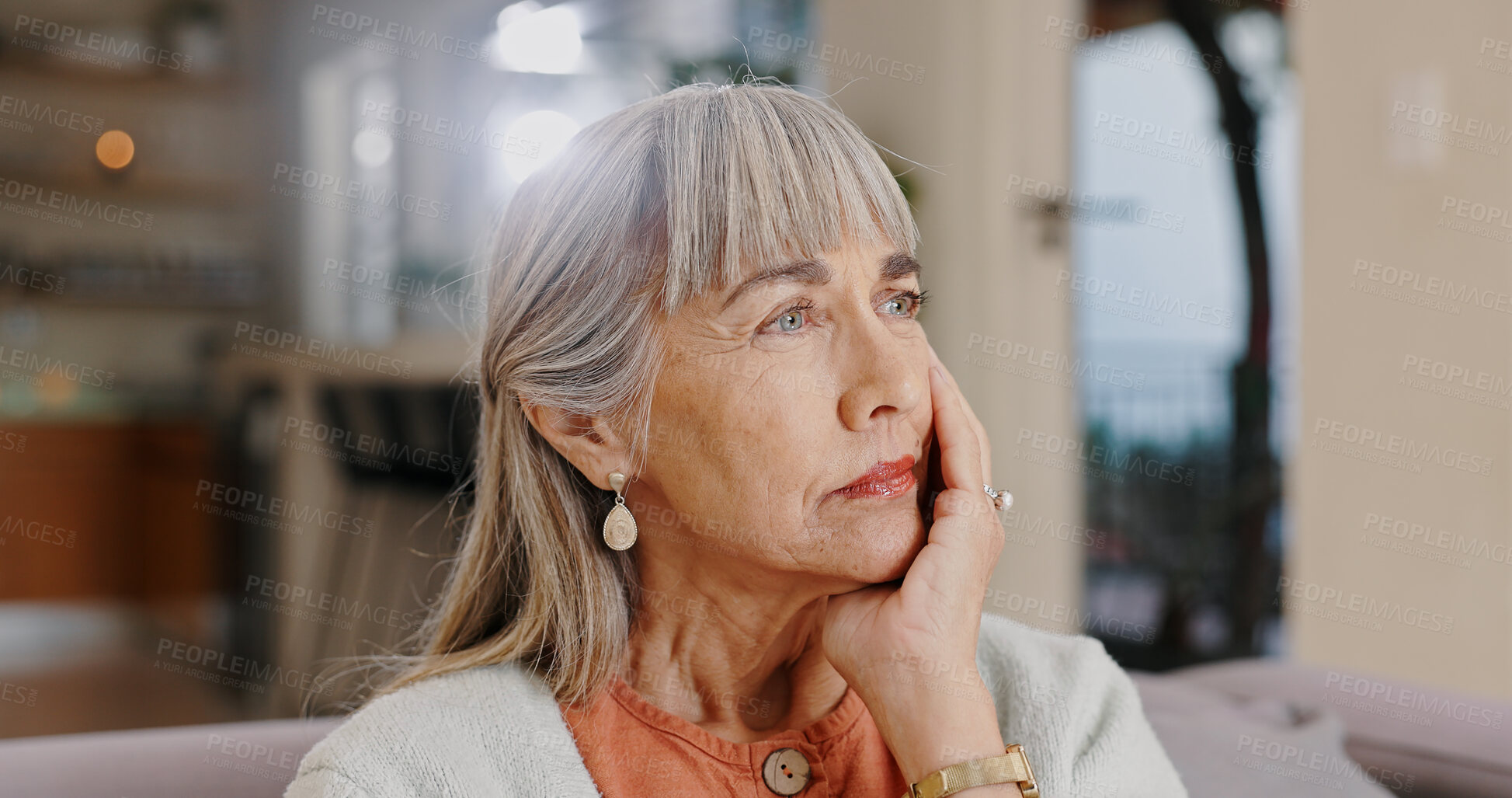 Buy stock photo Senior woman, thinking and sad in lounge, hand and memory of past, retirement and depression in nursing home. Grandma, lonely and couch of house, remember and elderly person in living room and grief