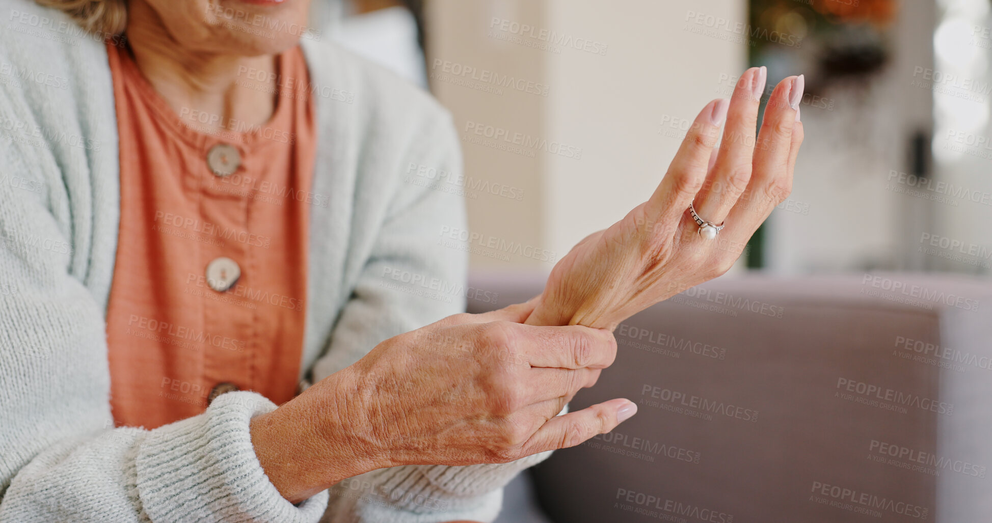 Buy stock photo Medical, wrist pain and senior person with arthritis, osteoporosis and fibromyalgia on sofa. Home, lounge and woman with hands massage for discomfort, bruise muscle and carpal tunnel in retirement