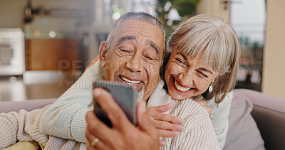 Buy stock photo Elderly couple, selfie and smile in lounge, hug and together in house, online and photography for memory. Home, profile picture and old man with woman, happiness and app in mobile and love in post