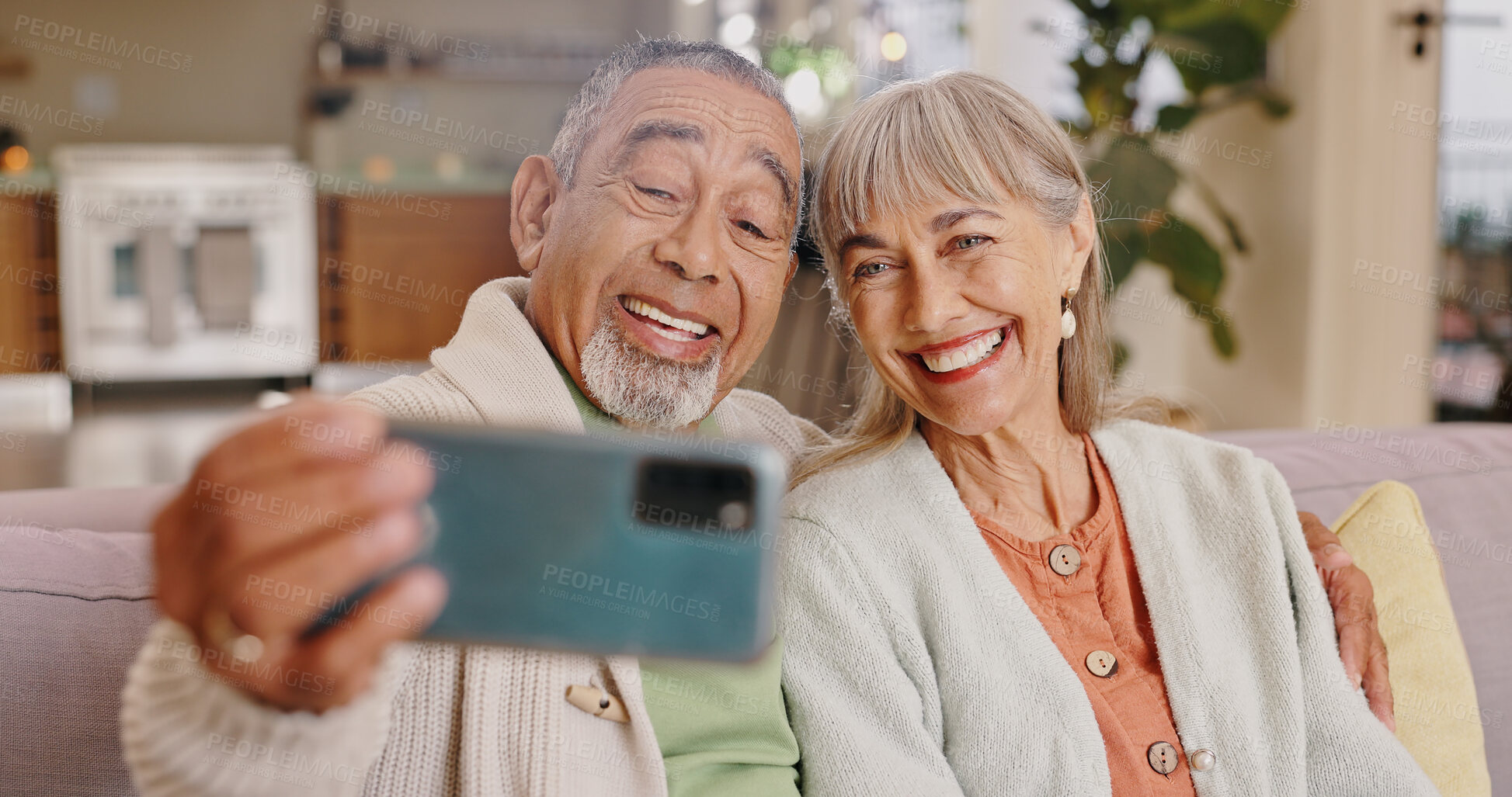 Buy stock photo Smile, senior couple and selfie in home living room for happy memory, love or laughing together. Man, woman and picture on sofa for social media post, retirement and interracial relationship in house