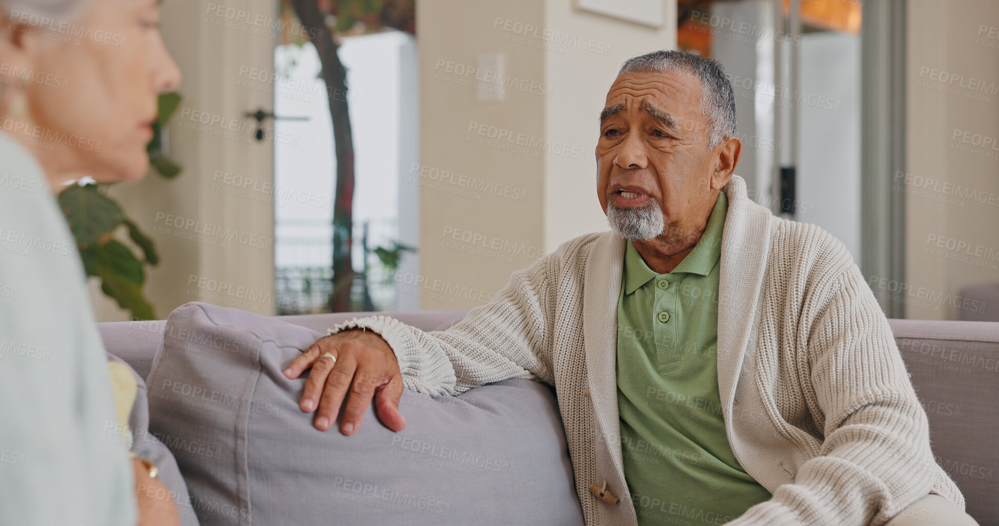 Buy stock photo Mad, lounge and senior couple, talking and woman in house, disagreement and communication with man. Living room, sofa and argument of mature people, conversation and fight to divorce of partner 