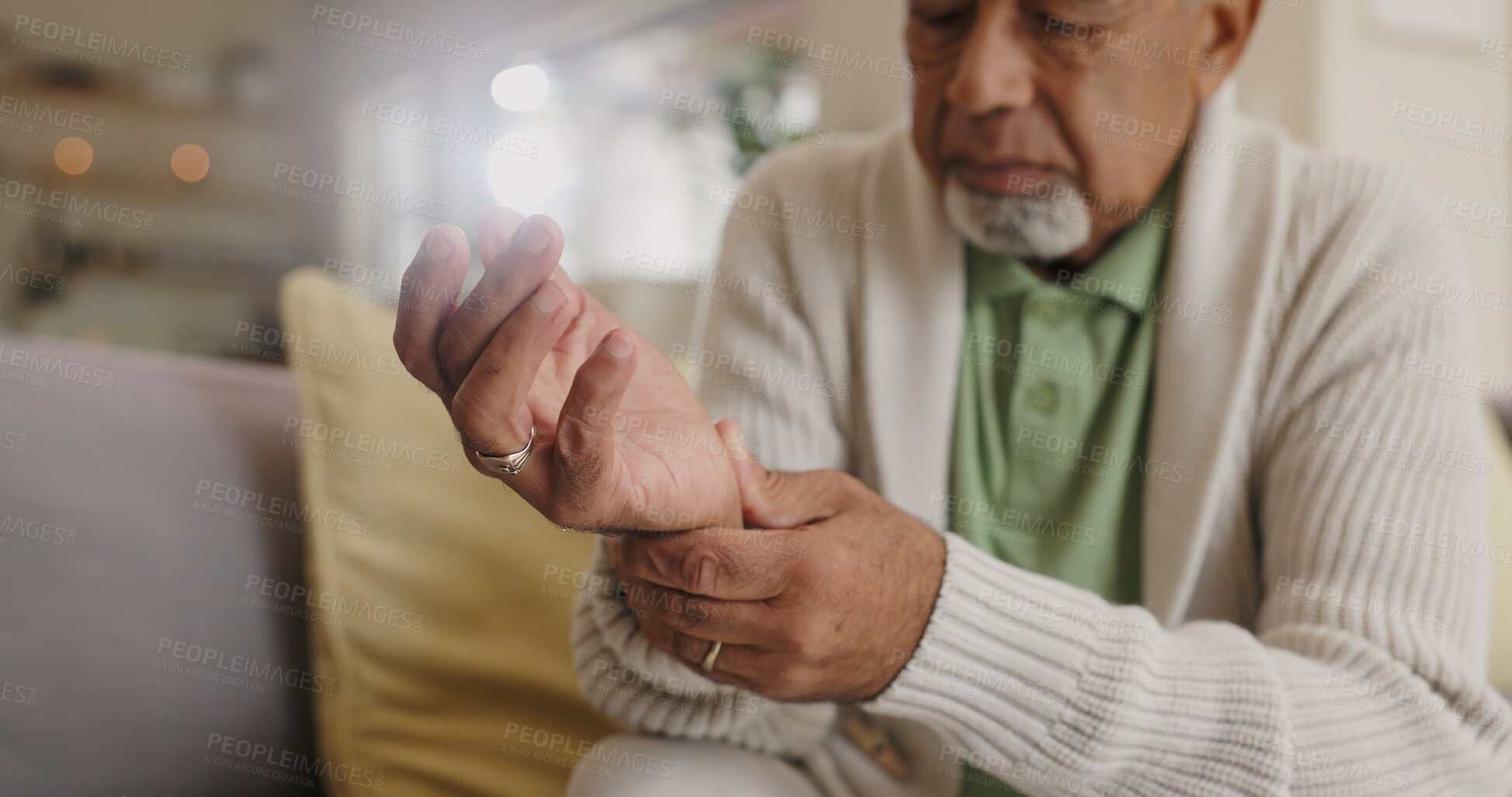 Buy stock photo Home, wrist pain and senior man with arthritis, osteoporosis and fibromyalgia on sofa. Medical, lounge and old person with hands massage for discomfort, bruise muscle and carpal tunnel in retirement