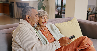 Buy stock photo Senior couple, home and remote for watching tv with retirement and streaming movie together. Interracial marriage, old man and woman on couch with change channel or click for online series with relax