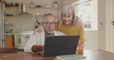 Buy stock photo Senior couple, home and laptop for internet research with  for retirement and social media update. Interracial marriage, old man and woman with computer in kitchen for video call app and virtual chat