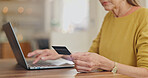 Credit card, hands or woman banking on laptop, internet or web for mortgage, bills or payment in home. Senior, ecommerce or closeup of person for online shopping deal or investment planning research
