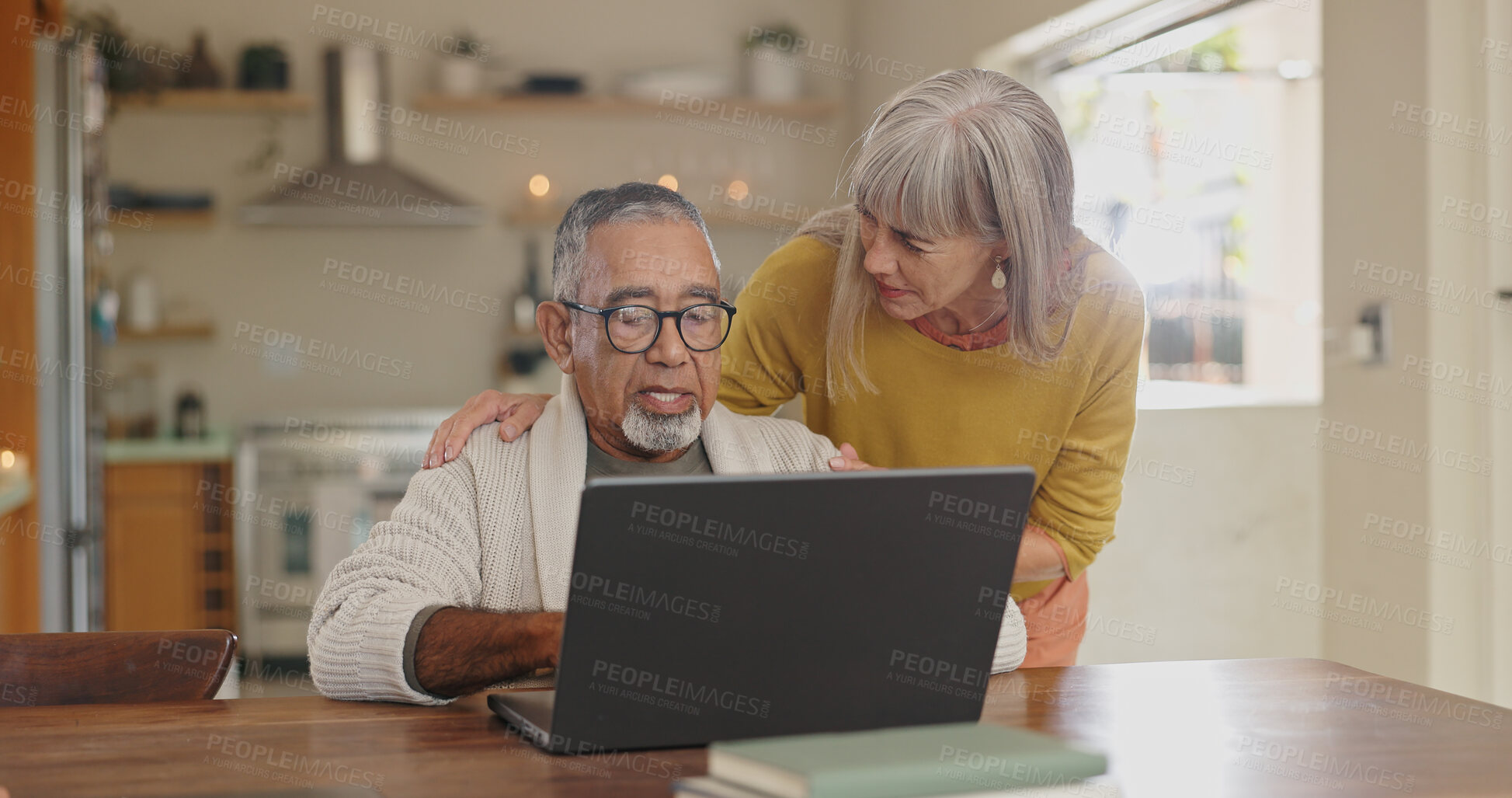 Buy stock photo Senior couple, kitchen and laptop with internet connection for reading news and pension article. Interracial marriage, old man and woman with computer in home for online faq about retirement research