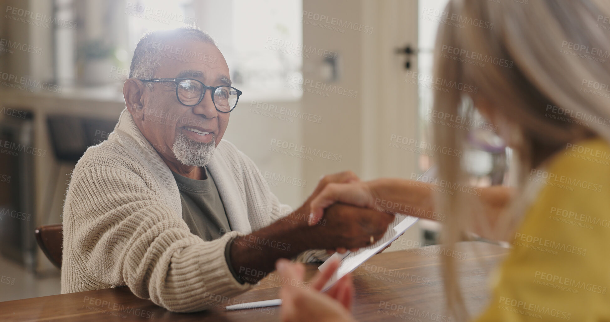 Buy stock photo Handshake, insurance or pension with senior man meeting finance broker in home for advice or deal. Agreement, contract or documents and elderly person shaking with agent in assisted living apartment