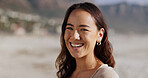 Asian woman, portrait and happy at beach for holiday, break and fresh air on day off in Atlanta. Smile, outdoor and confident in seaside on vacation as traveler on tour, trip and journey to explore