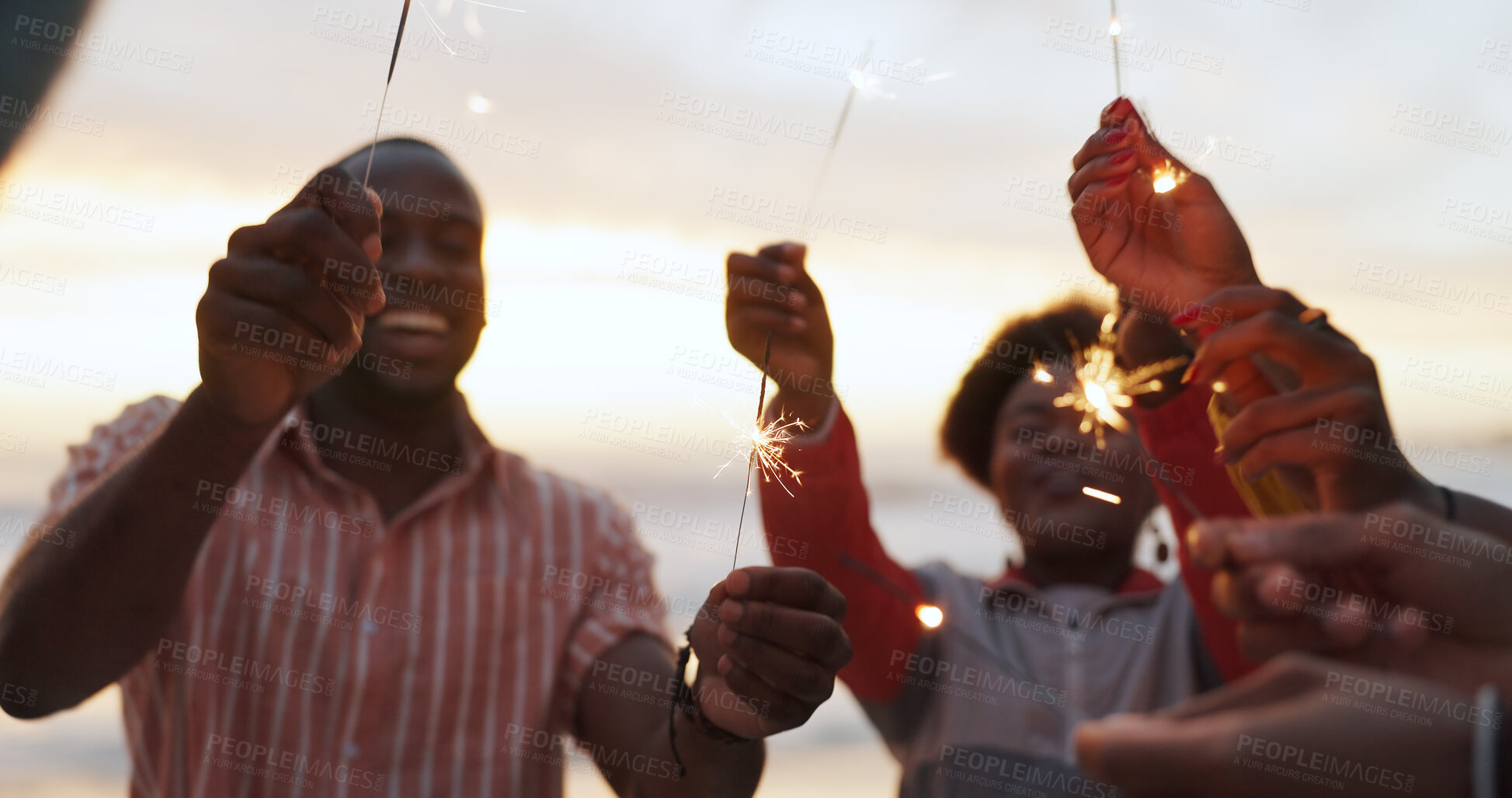 Buy stock photo Outdoor, sparkler and group of people at party with happiness, celebration and friends on vacation. Crowd, smile and fireworks on island holiday in Bali for travel, together for festival at sunset