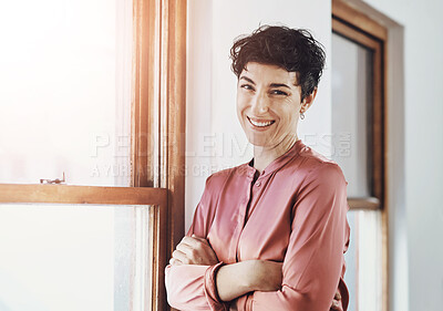 Buy stock photo Small business, woman or confident at window for portrait, professional or happy for opportunity. Female entrepreneur, arms crossed or smile in office for career success with startup growth in Spain