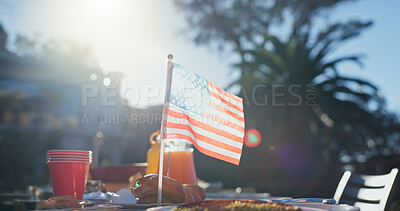 Buy stock photo USA flag, table and hamburger at outdoor party, sunshine and celebration for union in Florida. Cloth, symbol and sign with fast food, nature or trees in backyard for patriotism on Independence Day