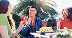 Conversation, alcohol and group of people outdoor for fourth of July celebration, social event or party. Toast, American flag and young friends bonding together at barbecue on terrace for weekend.