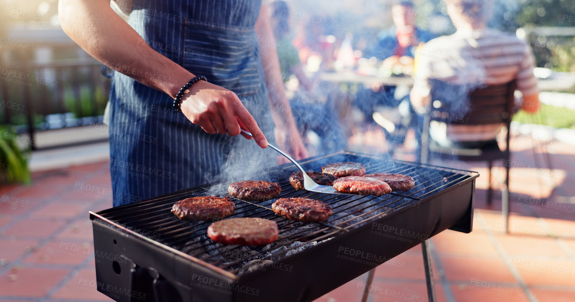 Buy stock photo Barbecue, lunch and man with burgers outdoor backyard for meal at reunion, social event or party on terrace. Grill, food and male person cooking patty, beef or meat for bbq dish on weekend at home.