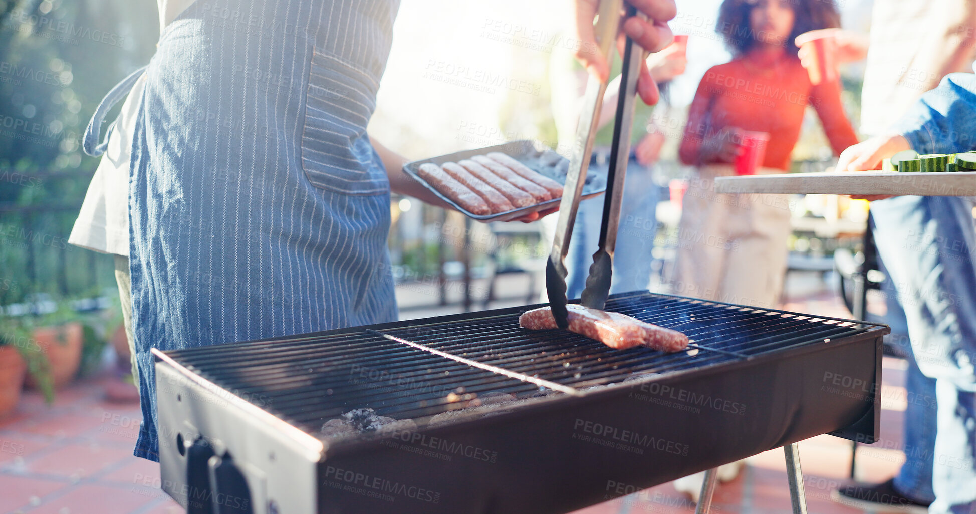 Buy stock photo Barbecue, food and man with sausage outdoor backyard for meal at reunion, social event or lunch on terrace. Grill, party and male person cooking meat and vegetables for bbq dish on weekend at home.