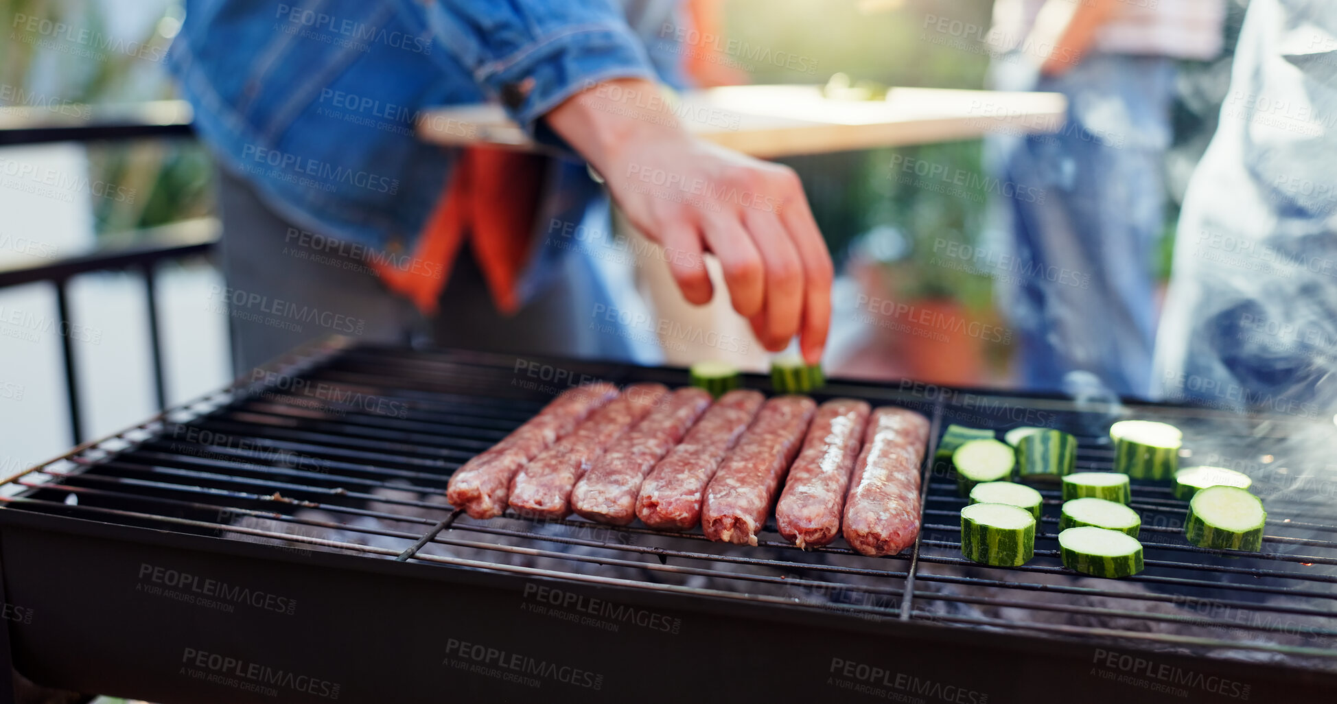 Buy stock photo Grill, food and man with sausage outdoor backyard for meal at reunion, social event or lunch on terrace. Barbecue, party and male person cooking meat and vegetables for bbq dish on weekend at home.