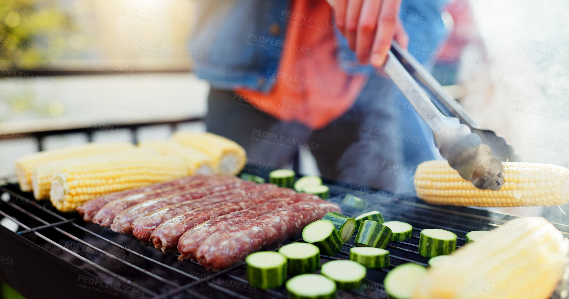 Buy stock photo Grill, food and man with sausage and vegetables outdoor backyard for meal at reunion, social event or lunch. Barbecue, party and male person cooking meat and produce for bbq dish on weekend at home