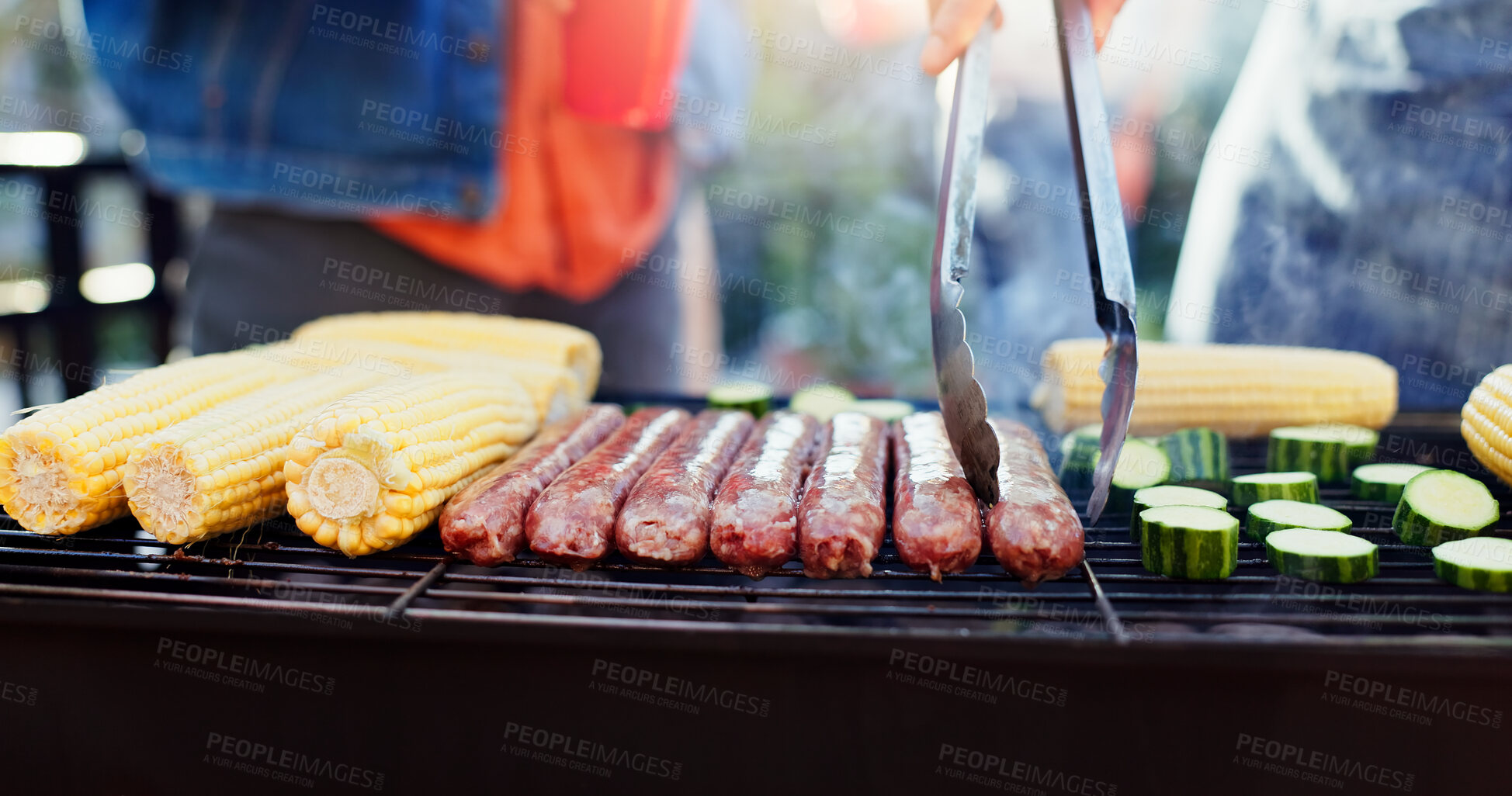 Buy stock photo Grilling, food and man with sausage and vegetables outdoor backyard for meal at reunion, social event or lunch. Barbecue, party and male person cooking meat and produce for bbq dish on weekend.