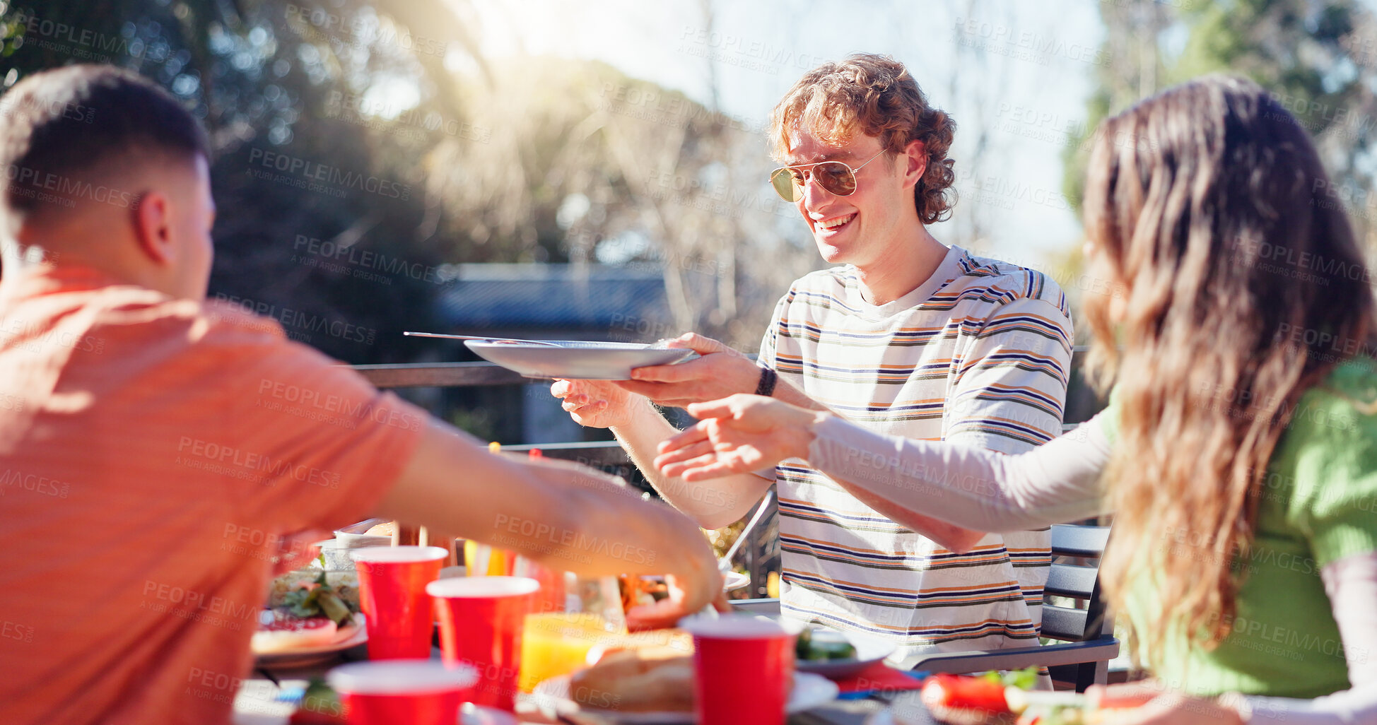 Buy stock photo Friends, people and eating bbq outdoor on terrace with conversation, reunion and social event in summer. Group, barbecue and lunch on patio with food, talking and celebration with bonding and drinks