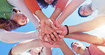 Friends, group and hands together with low angle outdoor for teamwork, unity and support in nature. People, team building and solidarity for collaboration, partnership and motivation with diversity