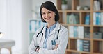 Happy woman, portrait and doctor with confidence for medical profession, career or healthcare at hospital. Female person, consultant or health professional with smile or stethoscope at office clinic