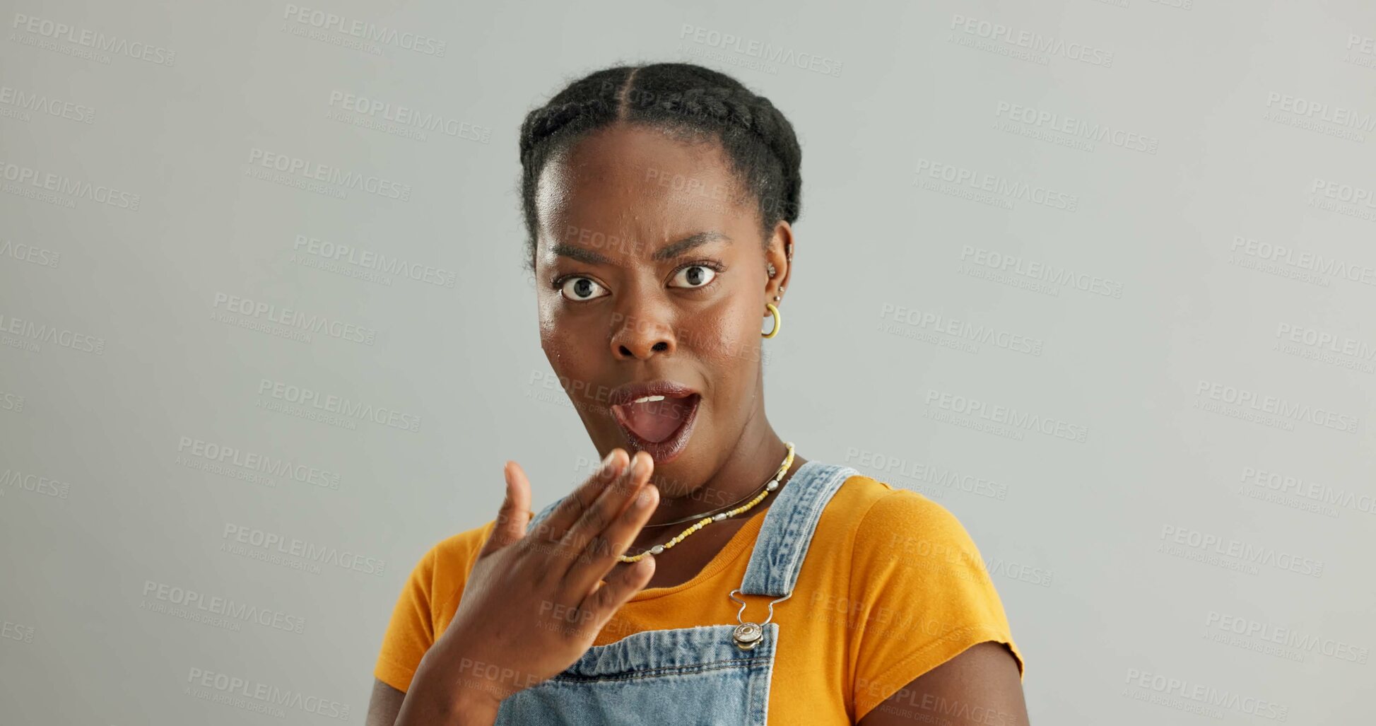 Buy stock photo Shocked, portrait and black woman in studio with wow for announcement, gossip or fake news on gray background. Wtf, mockup and person with hand covering mouth for secret, omg or unexpected revelation