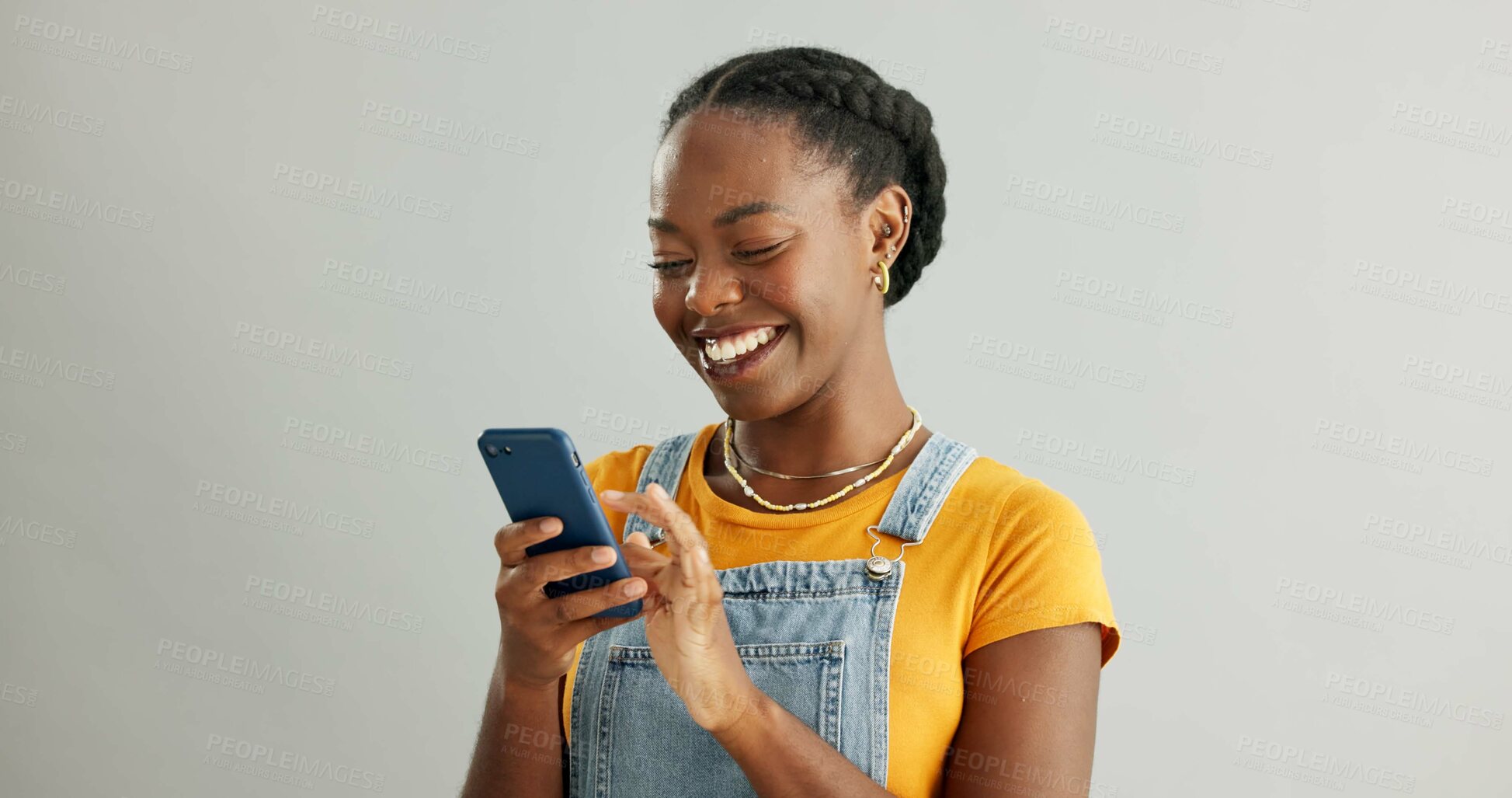 Buy stock photo African woman, phone and texting in studio with smile, reading or thinking for contact by white background. Gen z person, girl and happy with smartphone for chat, meme or social network on mobile app