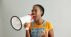 African woman, bullhorn and protest in studio with shouting, anger and announcement by white background. Gen z girl, student and activism with megaphone for human rights, justice or accountability