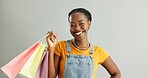 African woman, shopping bag and sale in studio portrait with smile for fashion choice by white background. Girl, product and customer experience with package, deal and discount with financial freedom