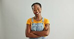 Portrait, joy and black woman with arms crossed, fashion and confident model on grey studio background. African person, face or happy girl with casual clothing, smile and trendy with stylish outfit