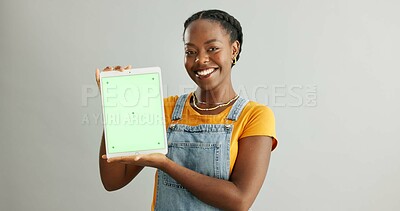 Buy stock photo Black woman, happy and green screen on tablet in studio background for advertising or promotion. Female person, portrait and smile in confidence with mockup space for marketing, app and media