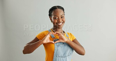 Buy stock photo Black woman, studio and heart sign for fashion with care, sustainable or eco friendly clothes for wellness. Female person, gray background and hands with love gesture, cool portrait in New York