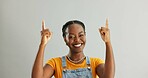 Portrait, pointing and black woman in studio for college registration, notification or information on gray background. Mockup, smile and person with hand gesture for opportunity, advice or decision