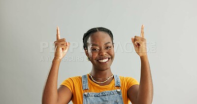 Buy stock photo Portrait, pointing and black woman in studio for college registration, notification or information on gray background. Mockup, smile and person with hand gesture for opportunity, advice or decision