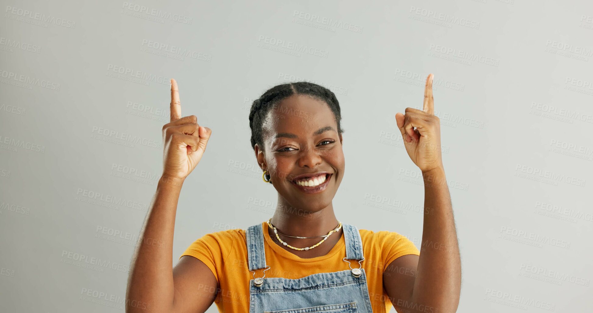 Buy stock photo Portrait, pointing and black woman in studio for college registration, notification or information on gray background. Mockup, smile and person with hand gesture for opportunity, advice or decision