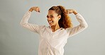Happy, portrait and woman flex in studio for achievement, satisfaction or celebration on gray background. Strength, victory and excited person for accomplishment, champion or winner with mockup