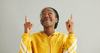 Buy stock photo Black woman, smile and hands pointing up in studio for presentation news, announcement or information of sales discount. Happy, African person and advertising launch, competition and white background