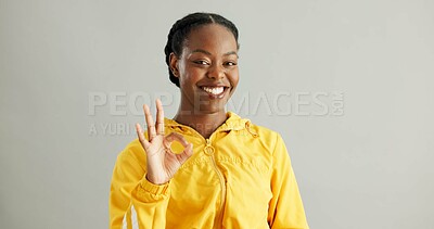 Buy stock photo Portrait, black woman and OK sign with smile, success and approval on grey studio background. African person, face or model with hand gesture, like and emoji with icon, yes or agreement with feedback