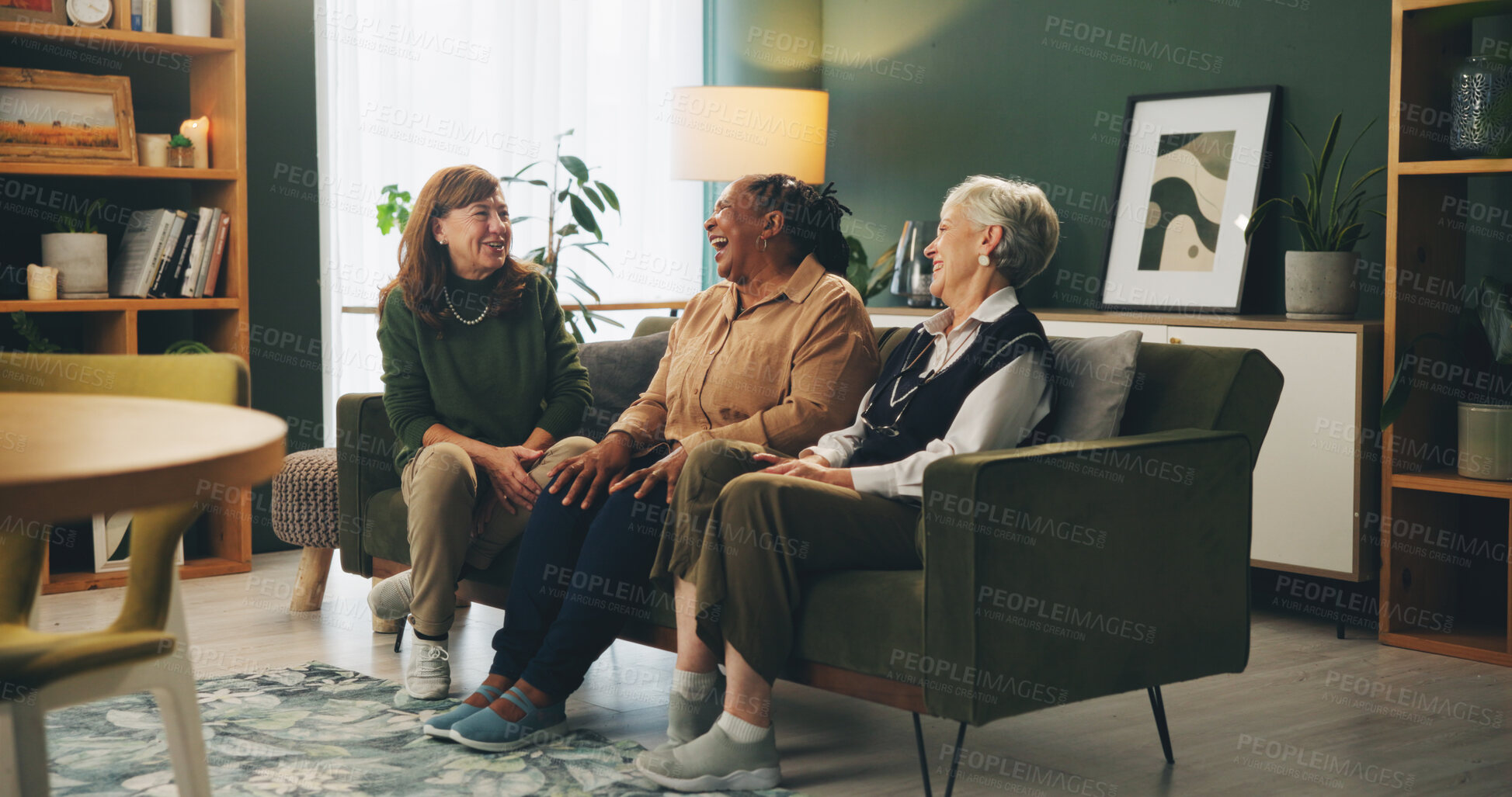 Buy stock photo Senior women, friends and laugh on sofa with funny story, memory or gossip with bonding in retirement. People, relax and conversation with smile, care or connection on couch in lounge at nursing home