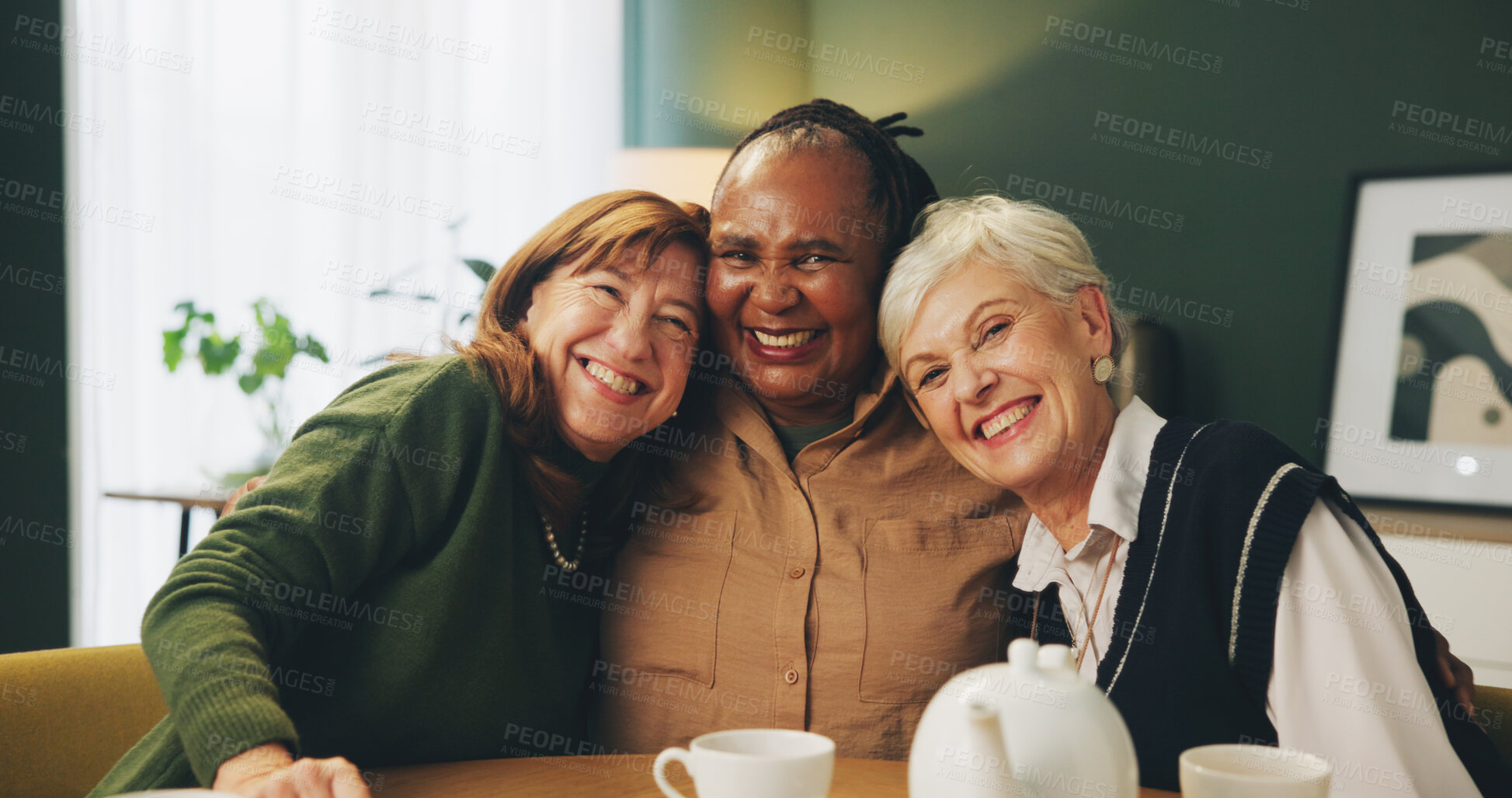 Buy stock photo Happy, hug and portrait of elderly women in house with care, trust and support, relax and bonding with drinks. Smile, face or senior friends embrace in retirement home for reunion, visit or tea party