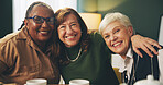 Happy, hug and portrait of senior women in house with care, trust and support, relax and bonding with coffee. Smile, face or elderly friends embrace in retirement home for reunion, visit or tea party