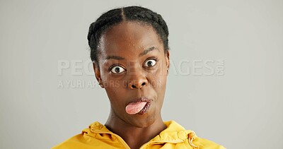 Buy stock photo Black woman, portrait or studio with tongue out for comedy, funny face with joke for comic. Female person, gray background or crazy for facial expression, goofy or silly pose for wellness in USA