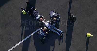 Buy stock photo Healthcare, emergency and first aid with paramedic team on street from above for medical treatment. Accident, medicine and group of EMT people on road with patient for assessment, CPR or response