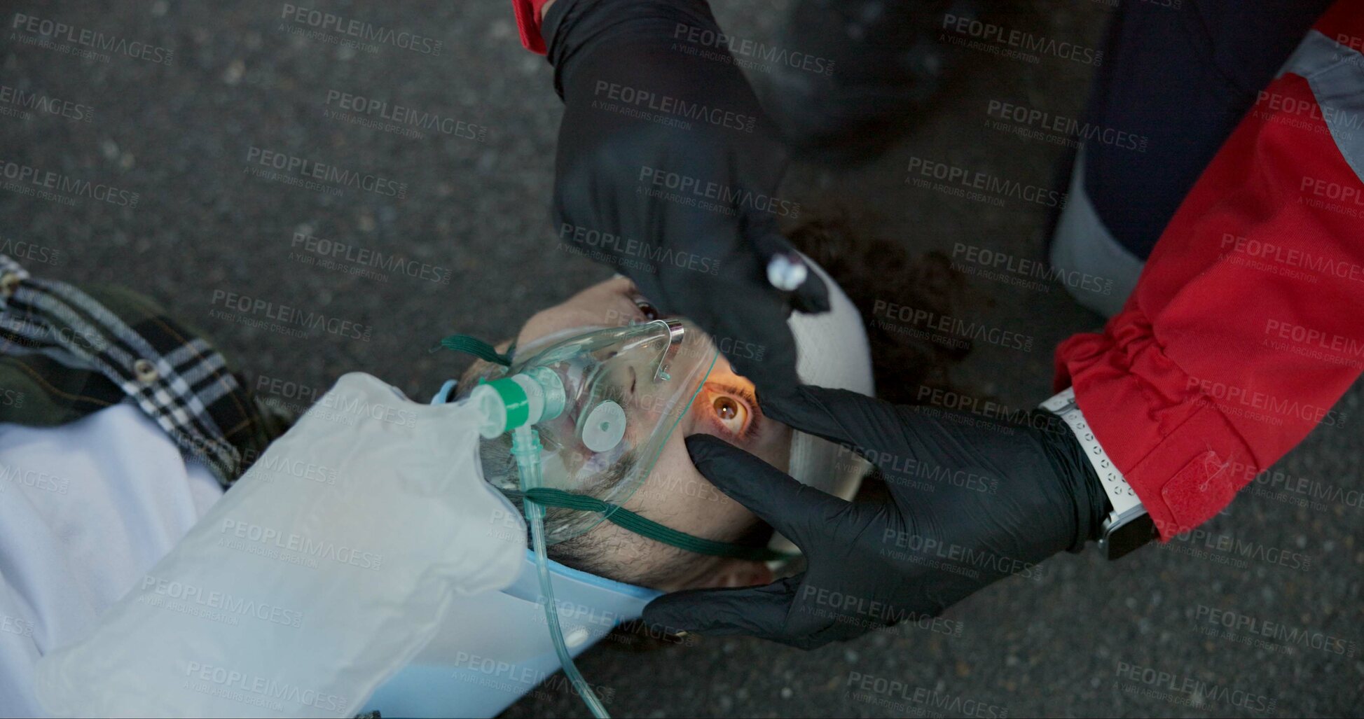 Buy stock photo First aid, paramedic and check man with flashlight for emergency ems service, accident and oxygen mask. Hands, medical or light on unconscious patient eyes for healthcare,  help or rescue in top view