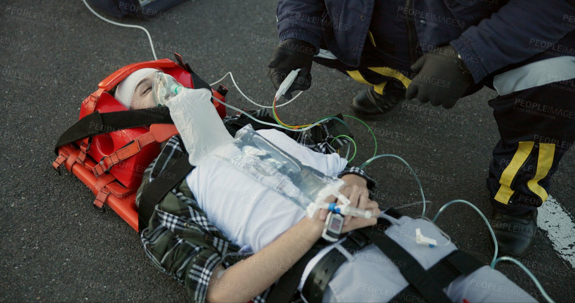 Buy stock photo People, paramedic and emergency with patient in road on scene for help, rescue and support. Emt team, healthcare and oxygen mask for injured person on accident for medical service, care and first aid