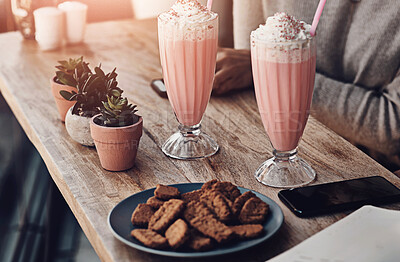 Buy stock photo Hands, milkshake and person at table in restaurant with phone, texting and cookies for snack at lunch. Dessert, biscuit and smoothie with smartphone for contact, social media and drink in cafeteria