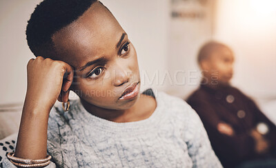 Buy stock photo Shot of an attractive young woman looking upset after having an argument with her boyfriend at home