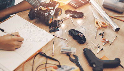 Buy stock photo Hands, notebook and person with robotics for education with machine learning for school project. Electronic vehicle, tools and engineering student with stem equipment for car circuit building at home